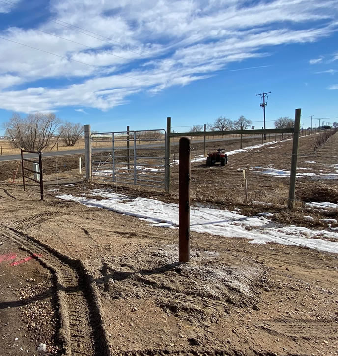 Ponderosa Style Pipe Property Fence with 4 1/2" Pipe Posts and 2 3/8" Drill Stem Pipe Rails. Blends nicely with Barbwire Fences. Construction by Integrity Welding Service LLC, servicing the Front Range of Colorado.