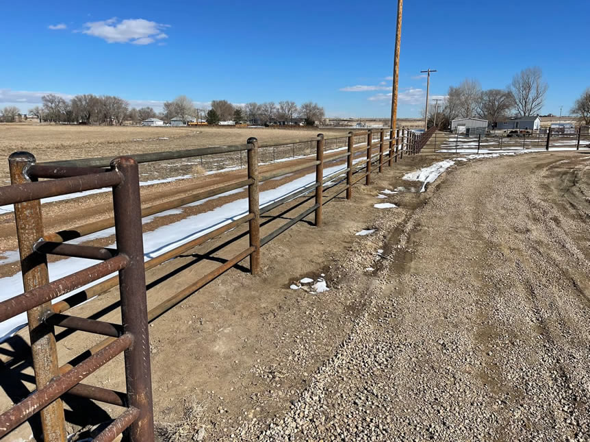 "Ponderosa" Style Pipe Property Fence. 4 1/2" Pipe Posts and 2 3/8" Drill Stem Pipe Rails. Construction by Integrity Welding Service LLC, servicing the Front Range of Colorado.