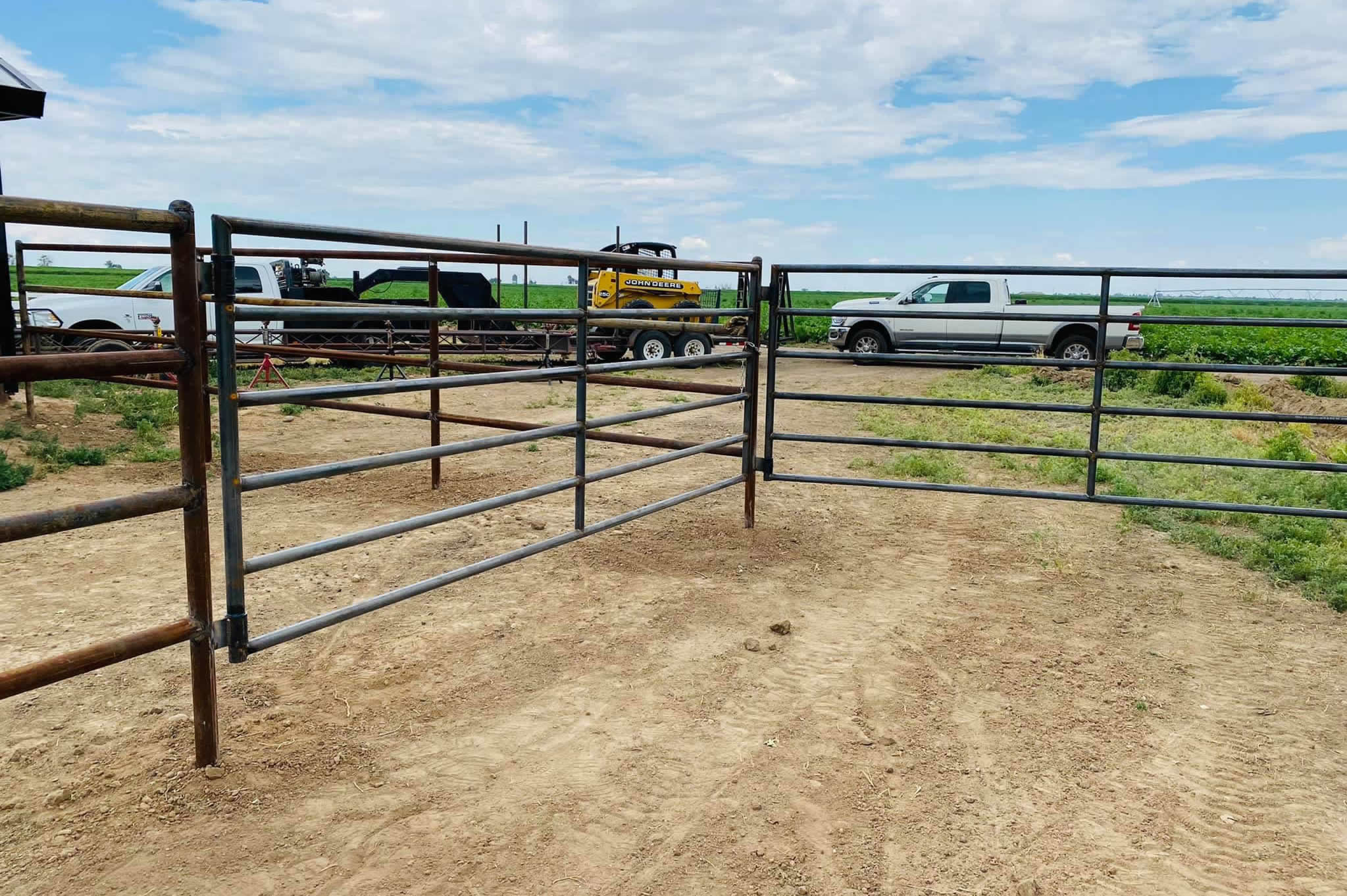 Pipe and Cable Fencing for a Riding Arena, complete with double gates and a custom flagpole. Construction by Integrity Welding Service LLC, servicing the Front Range of Colorado.